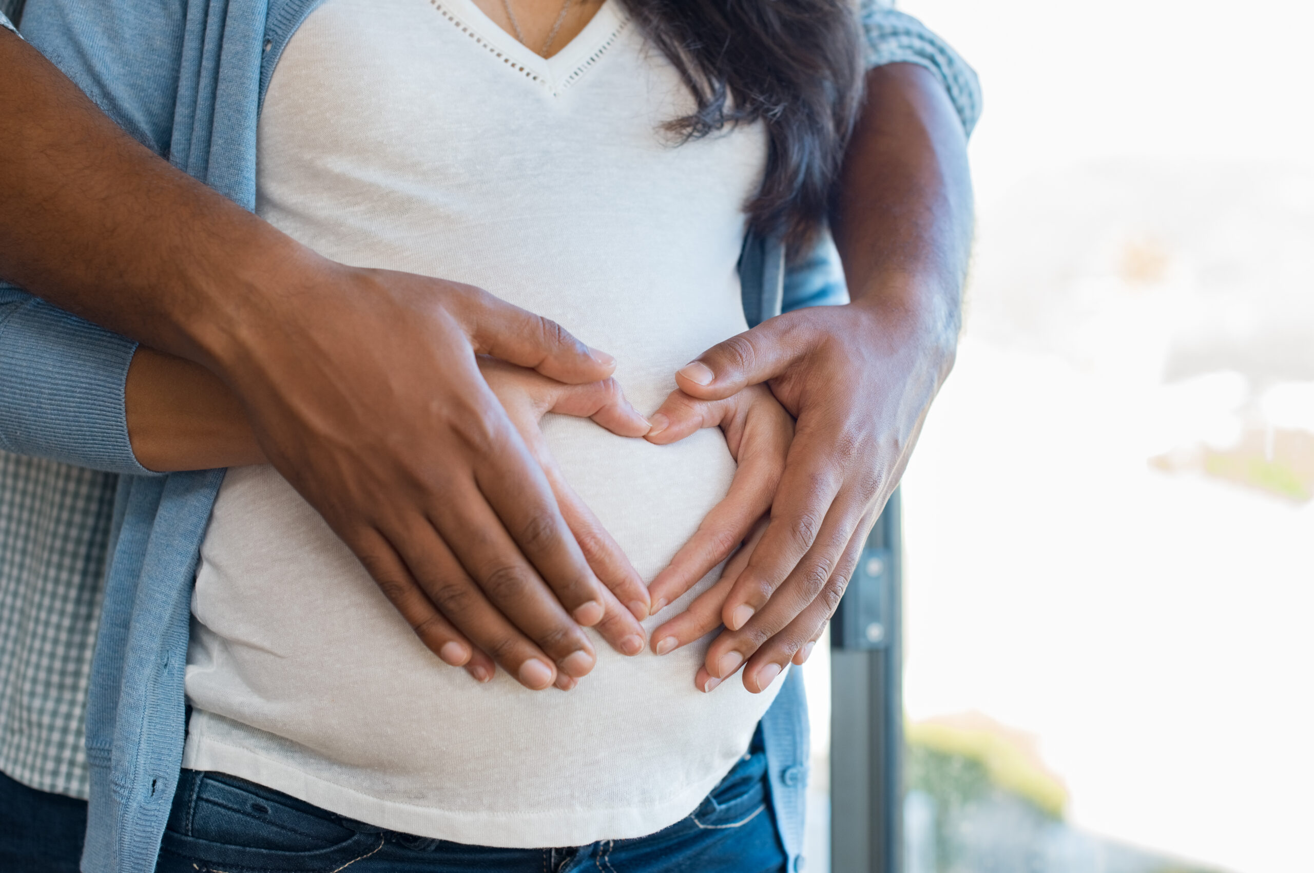 pregnant woman and heart hands - doula interview questions to ask