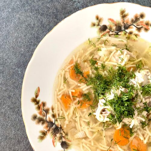 Postpartum chicken soup recipe with ginger, carrots, chicken, and herbs