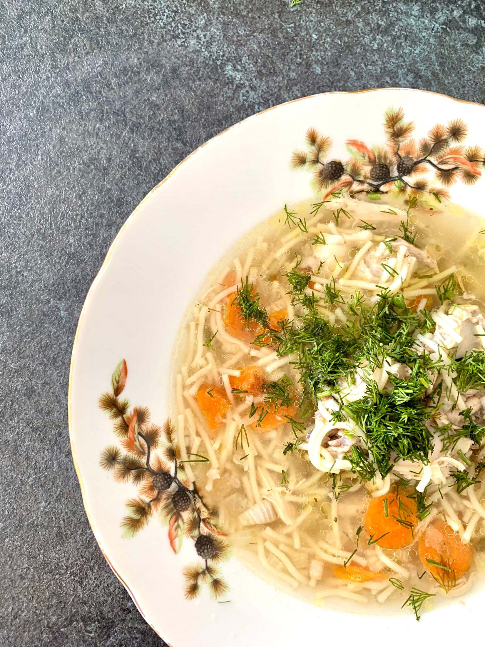 Postpartum chicken soup recipe with ginger, carrots, chicken, and herbs